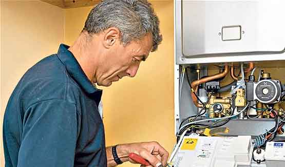 Home Emergency Cover for Landlords Engineer fixing a broken boiler under home emergency cover