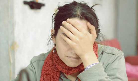 Female Landlord with hand over face looking stressed over Rent to Rent