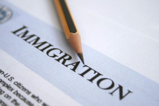 Document with the title immigration with a pencil over it.
