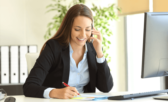 Lady in office on the phone as part of rent collection service for landlords.