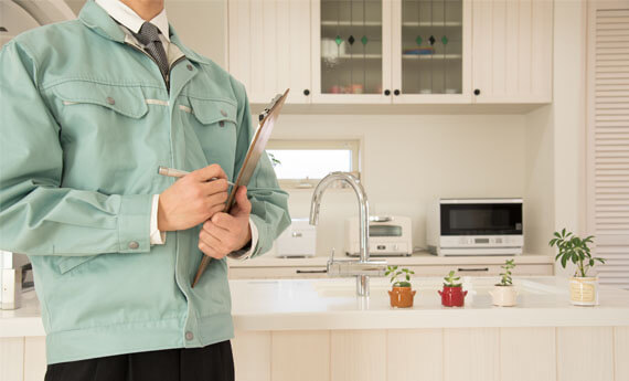 landlord standing in kitchen of property carrying out a property inspection