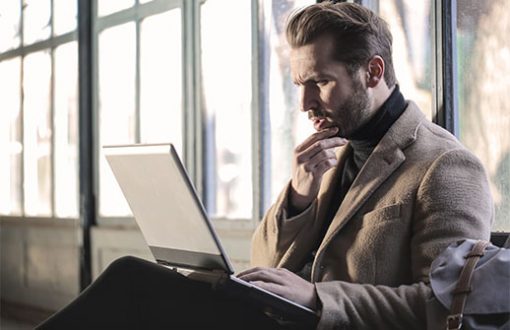 confused-man Confused man staring at a laptop